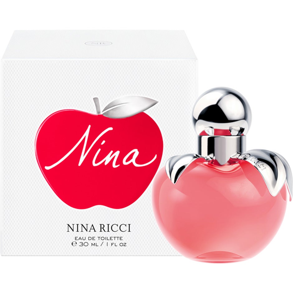 Elegant damparfymflaska Nina Ricci Nina mot ljus bakgrund