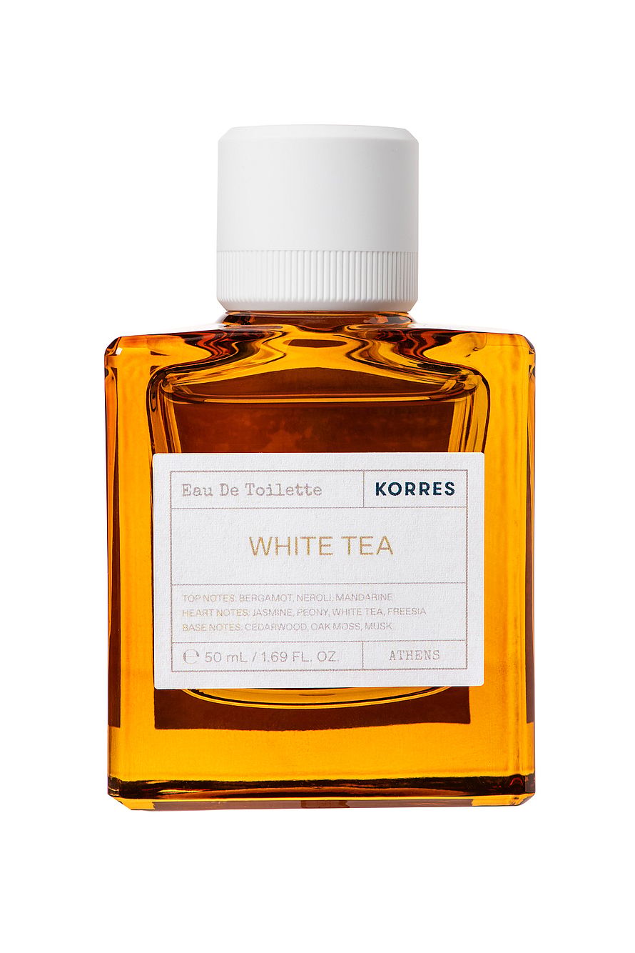 Vit parfymflaska av Elizabeth Arden White Tea Wild Rose damparfym med rosa rosdetaljer
